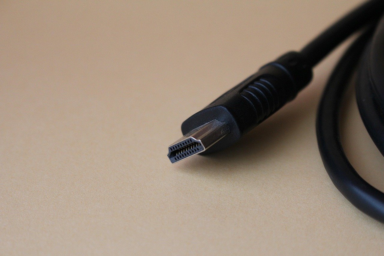 Close-up of an HDMI cable connector, the kind used to compare HDMI 2.1 versus HDMI 2.0 bandwidth and features
